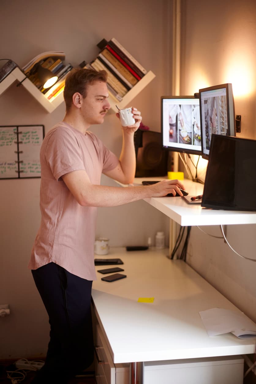 man working at a standing desk